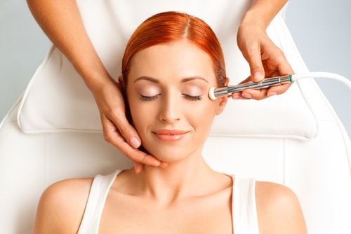 Closeup,Portrait,Of,Happy,Redheaded,Woman,Getting,Microdermabrasion,Procedure,In